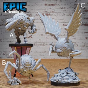 May include: Three gray miniature figurines. One is a robot with a large eye, another is a spider-like robot, and the third is a winged robot holding a blade. The figurines are on a wooden surface with a brick background. The logo "EPIC Miniatures" is in the top left corner.
