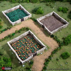 May include: Overhead view of three miniature garden plots with stone walls and small wooden gates. One plot is filled with green leafy plants, another with rows of brown soil, and the third with orange pumpkins. The scene is set on a dirt path with green foliage.