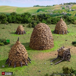 May include: A miniature diorama scene featuring four haystacks of varying sizes and a small wooden cart filled with hay. The haystacks are brown and conical, set on a green grassy field with a backdrop of trees and a blue sky.