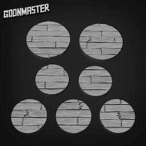 May include: Seven grey, circular wooden bases with a distressed, weathered appearance. The bases are designed to resemble wooden planks. The text "GOONMASTER" is in the upper left corner.