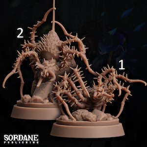 May include: Two detailed, beige-colored miniature figurines of a spidery creature with multiple legs covered in spikes. The creatures are posed on rocky terrain, with the base of each figure on a circular platform. The text "SORDANE PUBLISHING" is at the bottom.