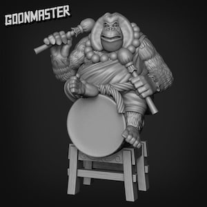 May include: A grayscale 3D-printed figurine of an ape-like character playing a drum. The character is seated on a small wooden stool and holds drumsticks. The text "GOONMASTER" is displayed in the upper left corner.