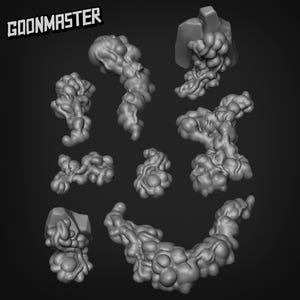 Puede incluir: Una colección de modelos grises de aspecto orgánico impresos en 3D, posiblemente para juegos de mesa o escenarios en miniatura. Los modelos tienen un aspecto texturizado y burbujeante, con la palabra "GOONMASTER" en negrita y estilizada.