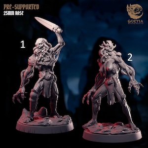 May include: Two detailed miniature figures of monstrous creatures. One figure holds a sword aloft, while the other stands with claws extended. The figures are on 25mm bases and are pre-supported. The Goetia Miniatures logo is visible.
