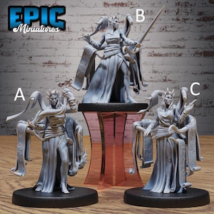 May include: Three grey resin miniature figurines labeled A, B, and C, each depicting a horned humanoid figure in a long robe with flowing scrolls. The figures stand on circular black bases, with figure B elevated on a translucent red stand.