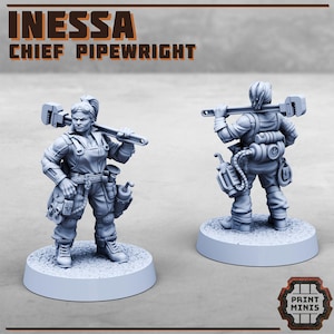 May include: Two gray miniature figurines of a character named Inessa, Chief Pipewright, holding a wrench. The figures are on round bases, with detailed workwear and tool accessories. The text "INESSSA CHIEF PIPEWRIGHT" is displayed above the figures.