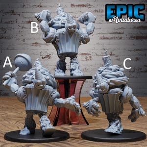 May include: Three grey miniature cupcake figures. One holds a lollipop, another has arms raised, and the third has arms at its sides. Each figure has a candle on top and is on a black base. The figures are for tabletop gaming.