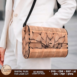 May include: A wooden crossbody bag with a black strap and a decorative leaf pattern. The bag is made of light brown wood and has a clasp closure. The image also includes text that says "DIGITAL FILES FOR LASER CUT" and "3D MODEL LASER CUT FILES".