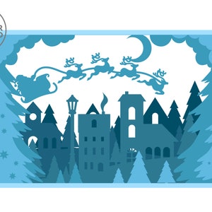 May include: A blue silhouette of a winter village with a crescent moon and Santa Claus flying overhead in a sleigh pulled by reindeer. The village is surrounded by pine trees and snow.