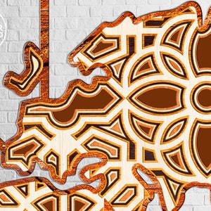 May include: A laser cut wooden design with a geometric pattern in shades of brown and beige. The design is intricate and detailed, with a variety of shapes and sizes.
