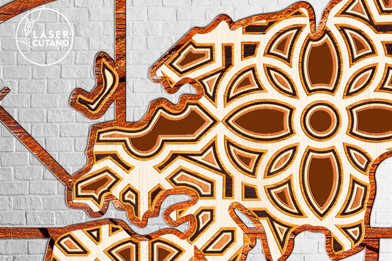 May include: A laser cut wooden design with a geometric pattern in shades of brown and beige. The design is intricate and detailed, with a variety of shapes and sizes.