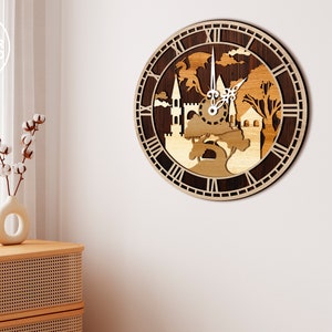 May include: A wooden clock with a dark brown background and a light brown design of a castle, trees, and a dragon. The clock face has Roman numerals and a white background.