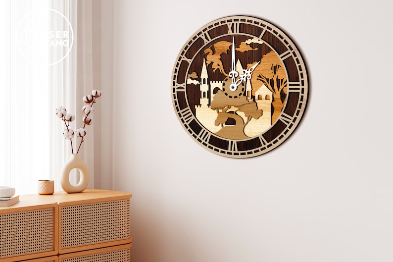 May include: A wooden clock with a dark brown background and a light brown design of a castle, trees, and a dragon. The clock face has Roman numerals and a white background.