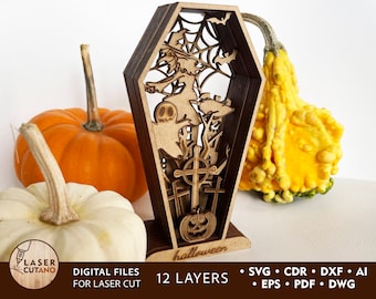 May include: A wooden Halloween-themed layered design with a witch flying on a broomstick, a ghost, a pumpkin, and a cross. The design is in a coffin shape and has 12 layers. The text "halloween" is written at the bottom of the design.