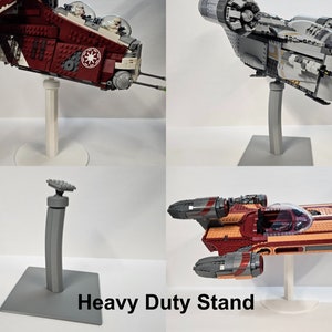 May include: Three different Lego Star Wars ships displayed on a gray heavy duty stand. The ships are a red and white ship, a gray ship, and a red, orange, and gray ship.