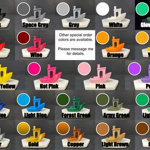 May include: A chart showing 20 different color options for a small boat figurine. The colors include black, space gray, gray, white, glow in the dark, red, wine, orange, yellow, bright yellow, hot pink, pink, purple, dark blue, light blue, forest green, army green, light green, silver, gold, copper, light brown, and brown.