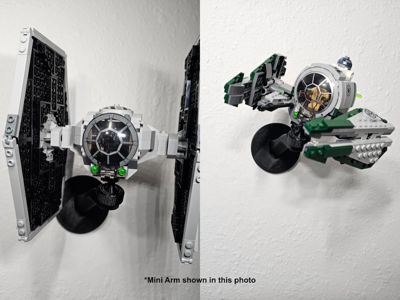 May include: A black plastic mini arm mount attached to a wall, supporting a gray and black TIE fighter model on the left and a green, gray, and white starfighter model with a small droid figure on the right. The text *Mini Arm shown in this photo is visible.