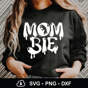 May include: Black sweatshirt with white text that reads "Mom-bie" with a dripping effect. The text includes a silhouette of a hand making an "OK" sign inside a circle.