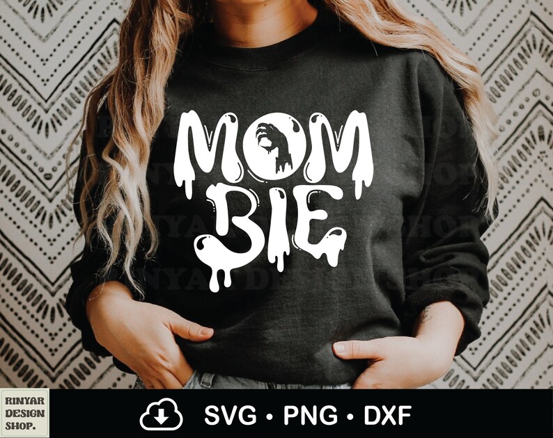 May include: Black sweatshirt with white text that reads "Mom-bie" with a dripping effect. The text includes a silhouette of a hand making an "OK" sign inside a circle.