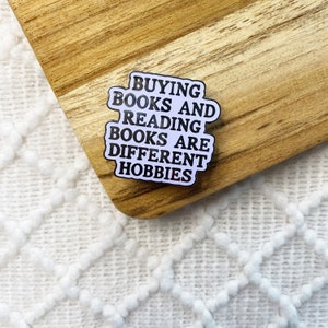 buying books and reading books are different hobbies enamel pin, bookish pin