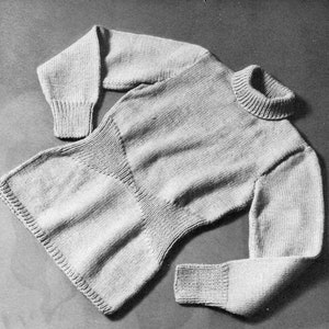 May include: A gray knitted turtleneck sweater with long sleeves and a fitted waist.