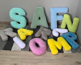May include: A set of colorful plush alphabet letters, including the letters S, A, F, N, R, I, O, M, and P. The letters are made of soft, fuzzy fabric and are perfect for a child's room or play area.