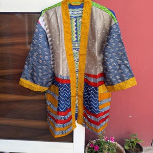 May include: A rustic wooden sign with the text "Welcome to our home" in white lettering. The sign features a distressed finish and a simple, inviting design, perfect for entryway decor.