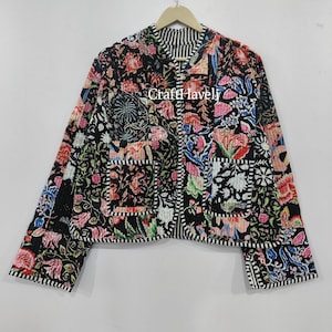 May include: A black quilted jacket with a floral print and a striped collar. The jacket has two pockets on the front and a button closure.