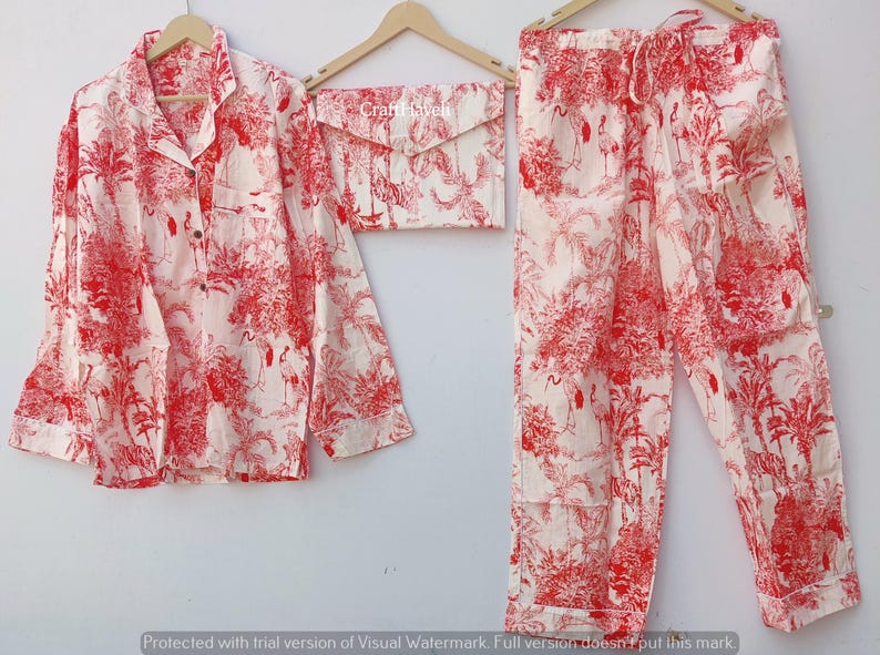 May include: A red and white pajama set with a floral print. The set includes a long-sleeved shirt with a button-up collar and matching pants.