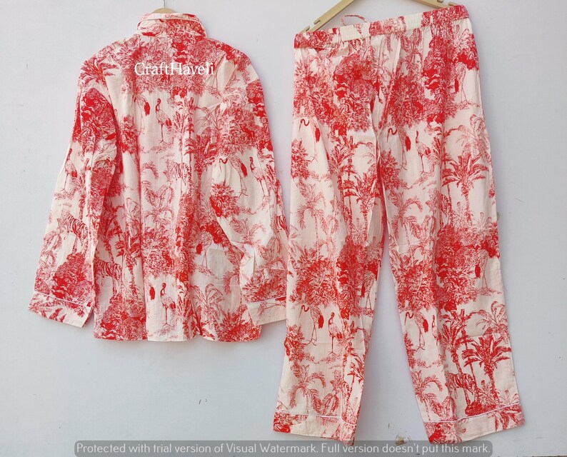 May include: Red and white pajama set with a floral print featuring birds. The top has a button-up front and long sleeves. The pants have an elastic waistband.