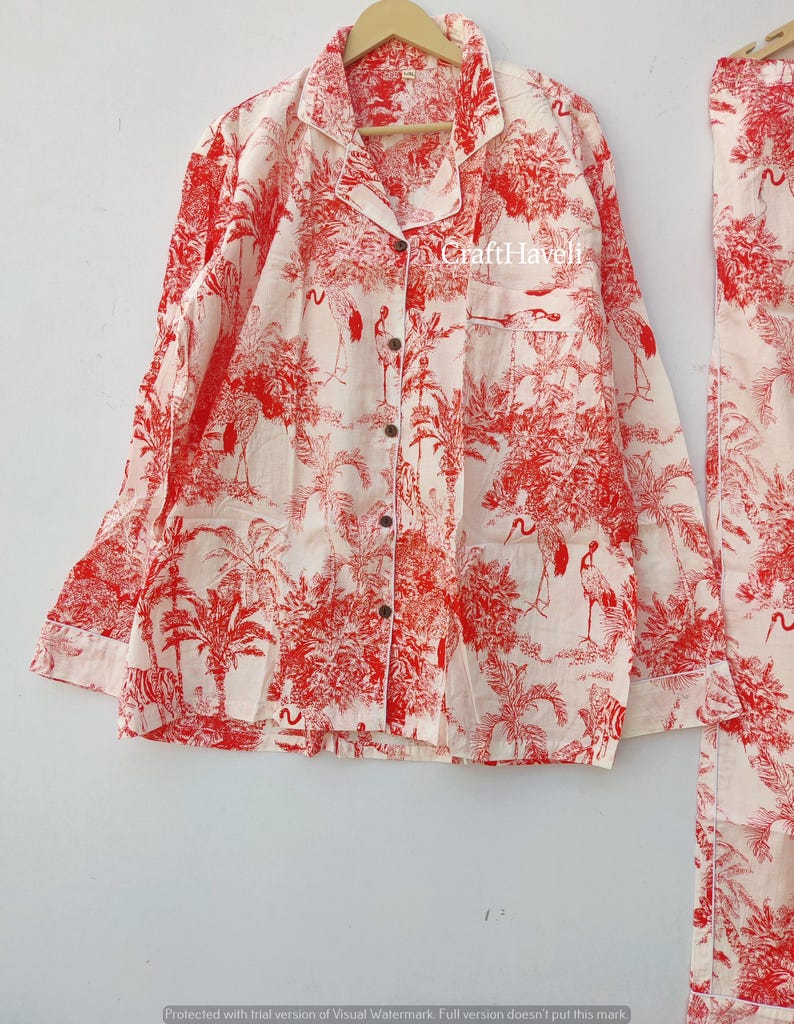 May include: A white pajama top with red and white floral print featuring palm trees and birds. The top has a button-up front and long sleeves. The text "Craft Haveli" is visible on the top.