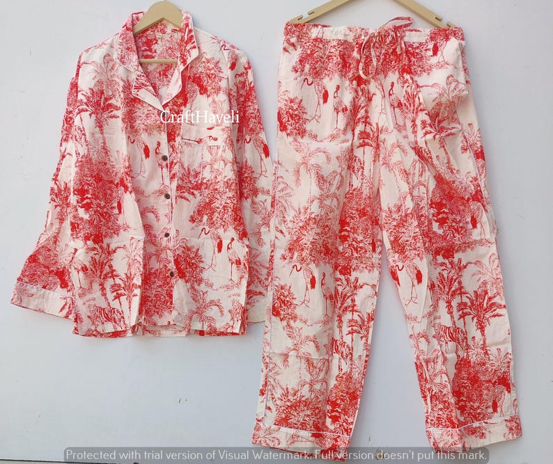 May include: Red and white pyjama set with a floral print. The top has long sleeves and a button-up front. The trousers have an elastic waistband.