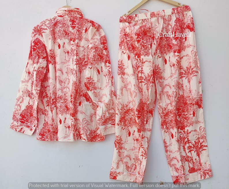 May include: A red and white pajama set with a floral print featuring birds. The set includes a long-sleeved shirt and pants.