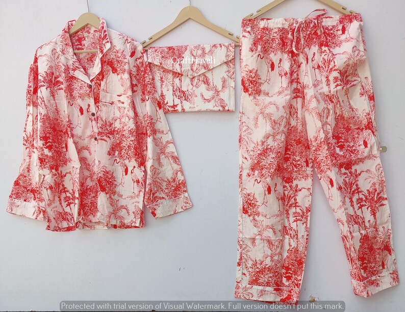 May include: A red and white pajama set with a floral print. The set includes a long-sleeved shirt with a button-up collar and matching pants.