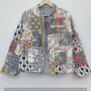 May include: A blue and white quilted jacket with a floral print and a striped lining. The jacket has a mandarin collar and a front zipper closure. The text "CraftHaveli" is printed on the front of the jacket.