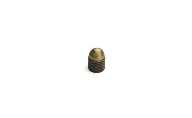 May include: A small, round, antique brass knob with a knurled base.
