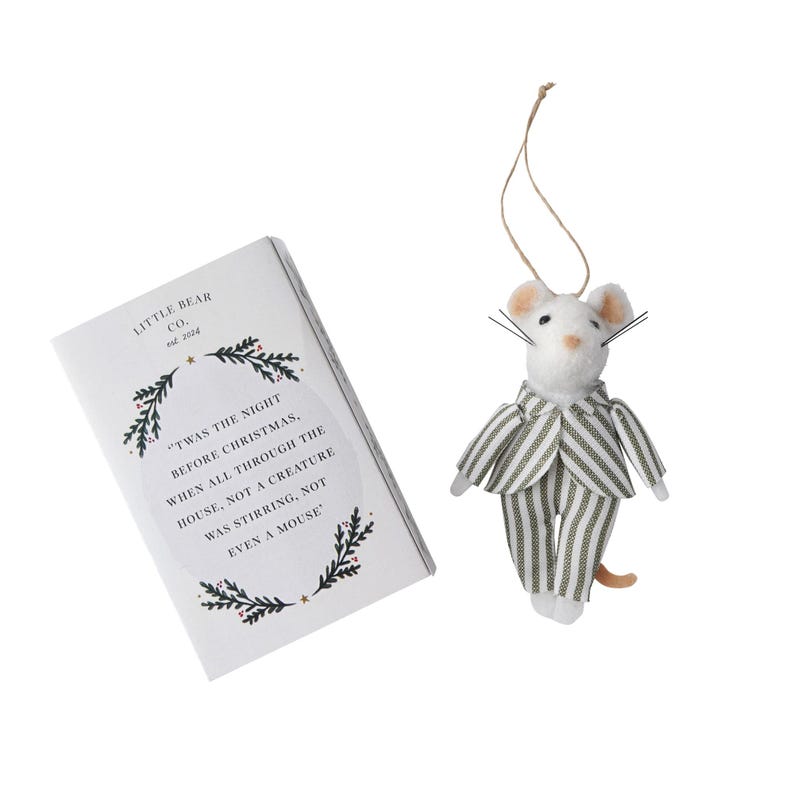 May include: A white felt mouse ornament wearing a green and white striped suit. The ornament is hanging from a string. The mouse is holding a small book with the text "'Twas the night before Christmas, when all through the house, not a creature was stirring, not even a mouse."