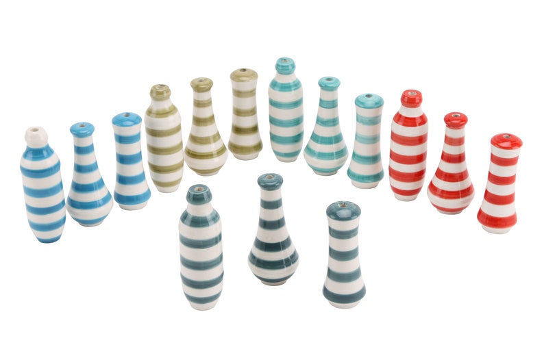 May include: A collection of 17 ceramic striped bottle stoppers in various colours, including blue, green, red, and white.
