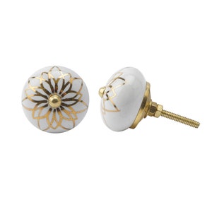 May include: White ceramic knob with a gold floral design. The knob has a screw for attaching to a drawer or door.