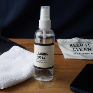 May include: A clear plastic spray bottle with a white cap and label that reads "CLEANING SPRAY" and "NET 100ML / 3.38 FL. OZ".