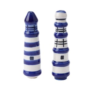 May include: Two ceramic lighthouse salt and pepper shakers. The shakers are painted in blue and white stripes with a blue roof.