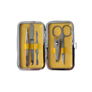 May include: A silver manicure set with a nail clipper, tweezers, a cuticle pusher, a nail file, and scissors. The tools are in a yellow and silver case.