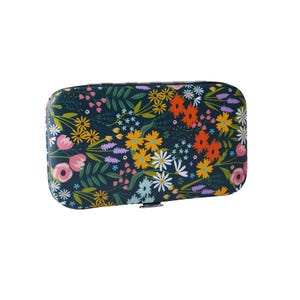 May include: A dark blue travel case with a floral pattern featuring pink, yellow, orange, and white flowers. The case has a metal clasp.