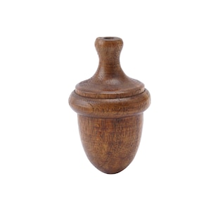 May include: A dark brown, acorn-shaped wooden object. It features a rounded base, a textured body, and a slender, cylindrical top. The object is likely a decorative item or a furniture component, possibly a finial or a knob.