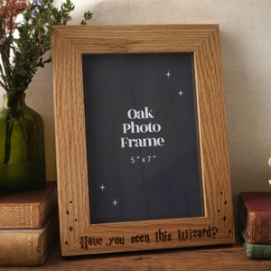 May include: A 5x7 inch oak photo frame with a dark background and the text "Have you seen this Wizard?" engraved on the bottom. The frame has a rustic look and is perfect for displaying a favourite photo.