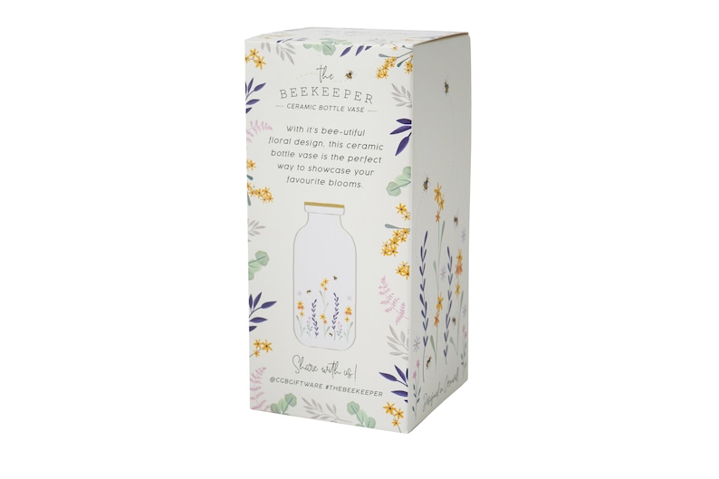 May include: White ceramic bottle vase with a floral design featuring bees and flowers. The vase is packaged in a box with a floral design and the text "The Beekeeper Ceramic Bottle Vase".