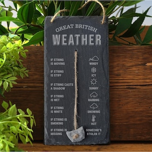 May include: A slate weather gauge with the text "GREAT BRITISH WEATHER". It features a string with a stone weight and weather condition indicators: windy, icy, sunny, raining, snowing, hot, and "someone's stolen it". A jute string is used for hanging.