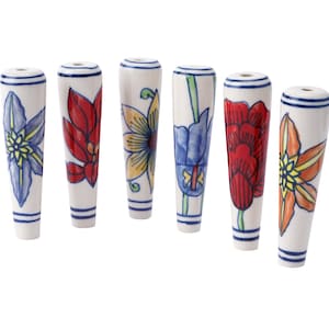 May include: Six white ceramic drawer pulls with hand-painted floral designs in various colours, including blue, red, yellow, and orange. Each pull has a cylindrical shape with a small hole at the top and blue stripes.