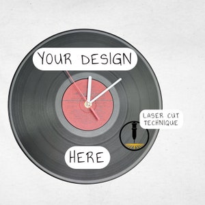 May include: A black vinyl record clock with white hands and a red center label. The clock face says "YOUR DESIGN HERE" and "LASER CUT TECHNIQUE".