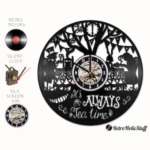 May include: Black vinyl record clock featuring a silhouette of the Mad Hatter and the March Hare having tea in a forest setting. The clock face reads "It's Always Tea Time".